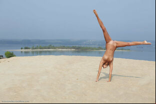 Limber blond Afina meditating nude and opening up on the